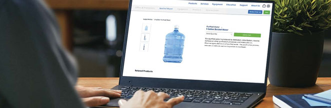 A person placing a water order on a laptop