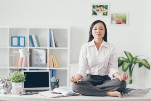 Woman meditating on desk