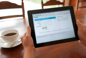 woman logging onto LinkedIn on tablet