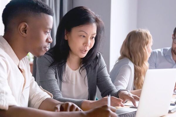 People collaborating and working on a laptops