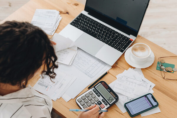 women at the table with calculator