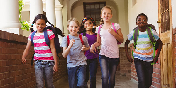 4 students running on hallway