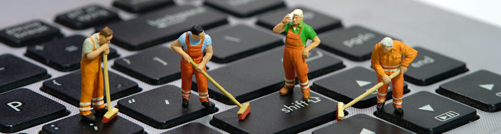 Tiny human standing on keyboard mopping.