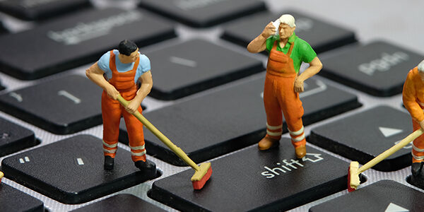 Tiny human standing on keyboard mopping.