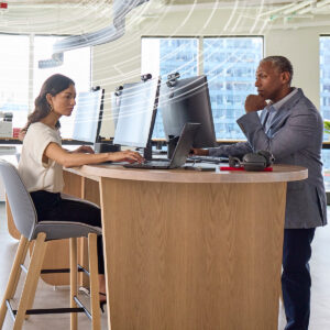 A man and a woman sitting at a desk working.