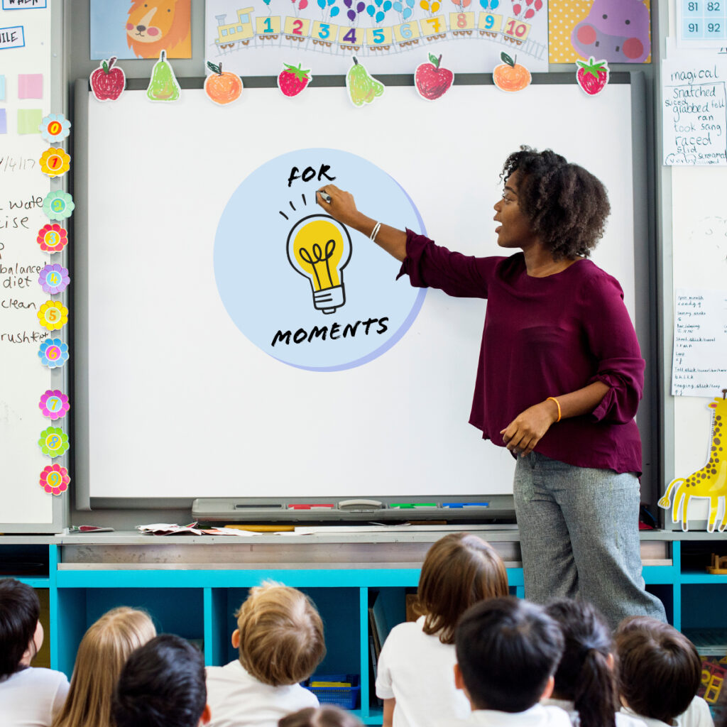 A teacher teaching in front of a whiteboard.