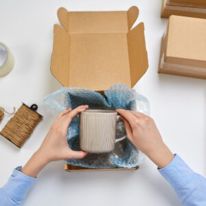 A mug in a small box with bubble wrap