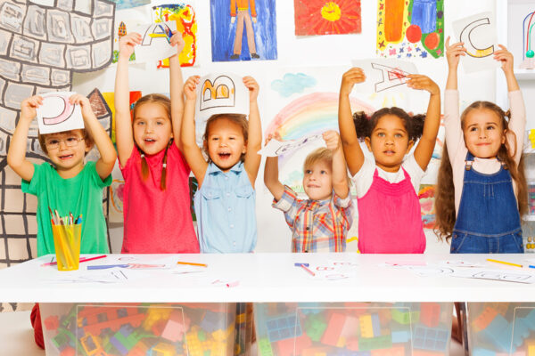 Students holding up coloring sheets