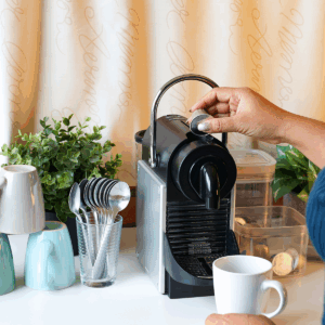 a table with coffee maker and a mug
