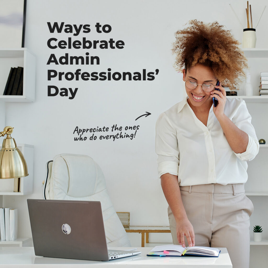 A woman standing in front of a desk talking on phone