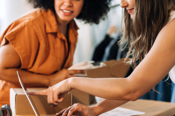 Two women looking at a laptop