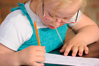 Girl with down syndrom writing