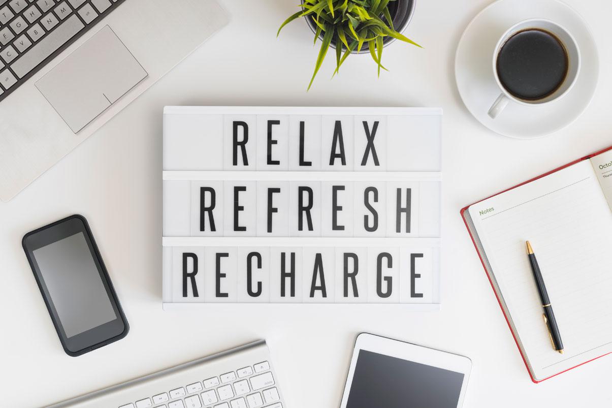 Words on a desk saying Relax, Refresh, Recharge