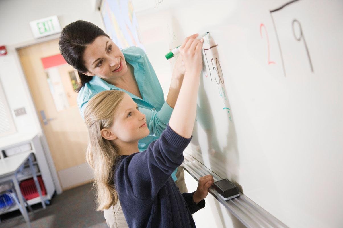 Teacher and student at white board