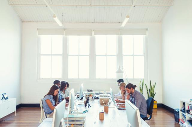 People working at a long table