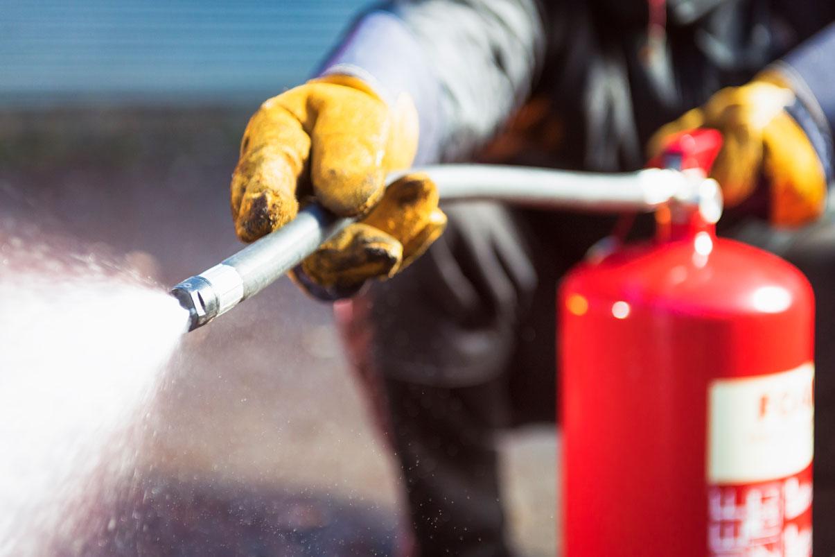 Fire fighter using fire extinguisher