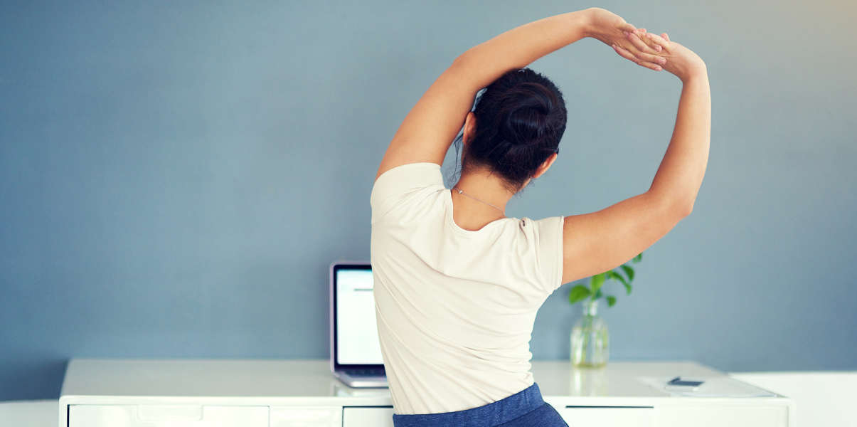 Woman stretching at her desk