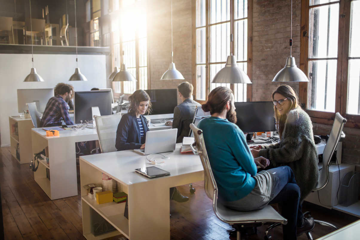 Coworkers collaboaring with each other in a contemporary office environment