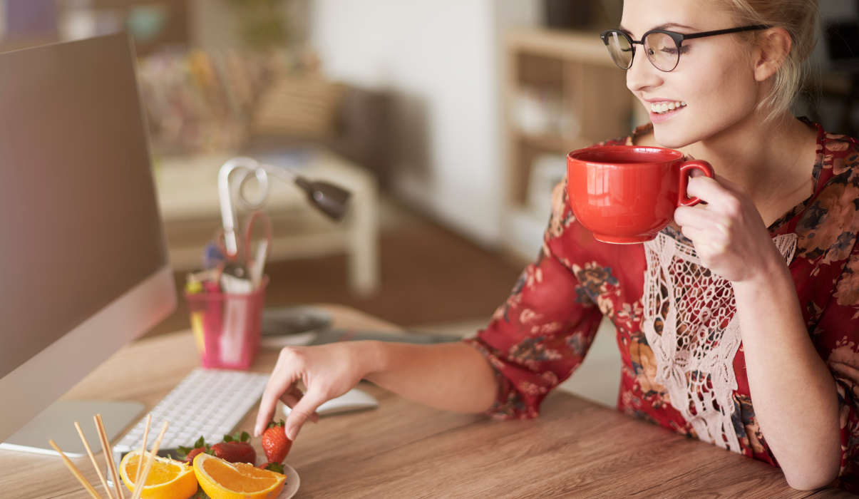 Woman enjoying light snack at work