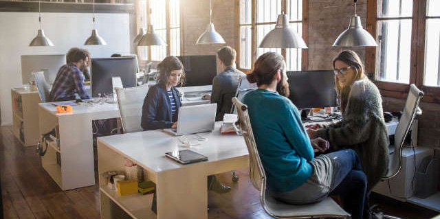 Coworkers collaboaring with each other in a contemporary office environment