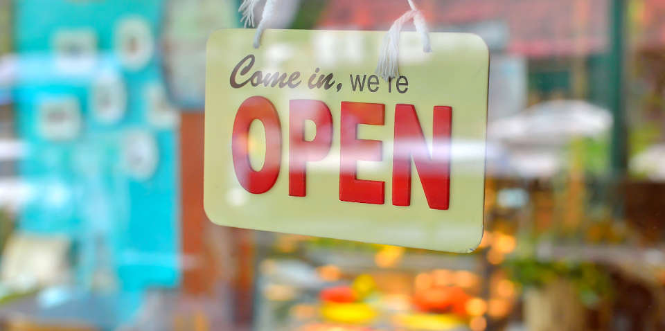 Open sign in shop window.