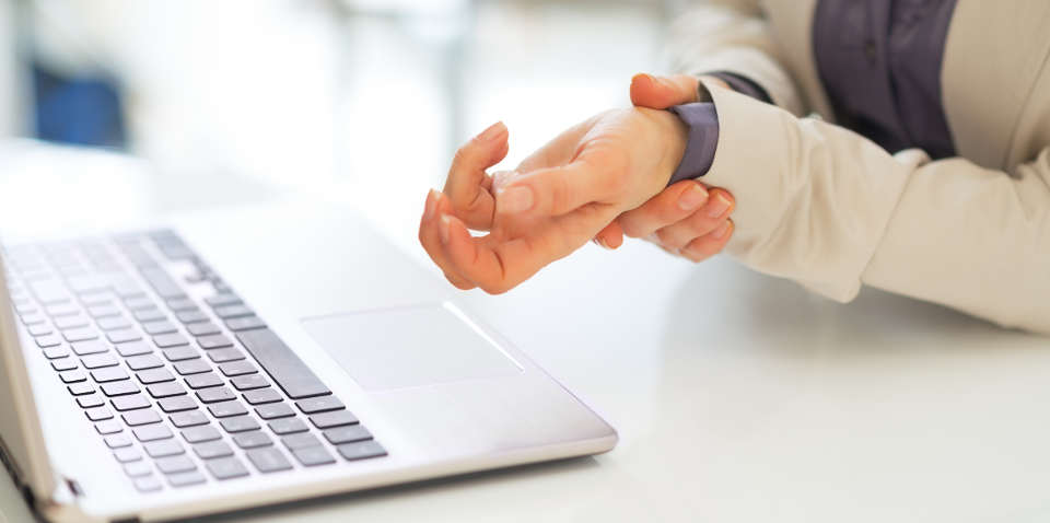 Closeup of business woman with wrist pain