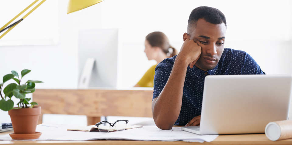 Office worker bored with his slow laptop