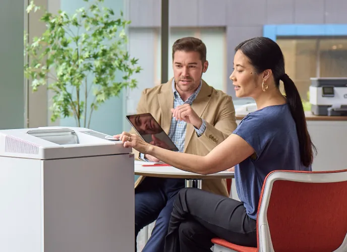 Image of two people by a printer