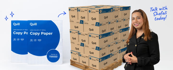 Quill Copy Paper stacked on a pallet with sales expert Shefali